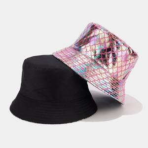 Close-up of double-sided bucket hat showing colorful fish scale pattern and black fabric