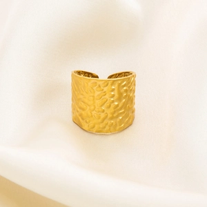Macro shot of 18K gold plated stainless steel ring featuring unique hammered rock texture