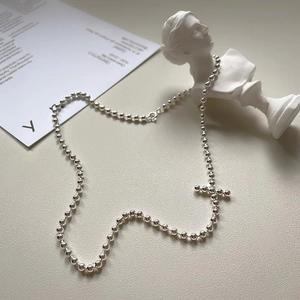 Minimalist 925 silver beaded chain necklace with a cross pendant on aesthetic background