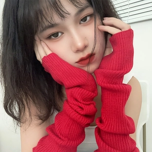 Close-up of bright red ribbed knit arm sleeves showing detailed texture and warm fabric