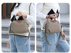 Detail of waterproof nylon handbag with brown leather handles and adjustable shoulder strap