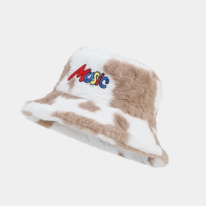 Detail of faux fur bucket hat with cow print pattern and colorful Music embroidery