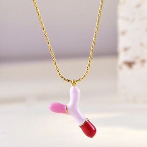 Close-up of pink and white enamel letter Y pendant on a delicate gold chain necklace