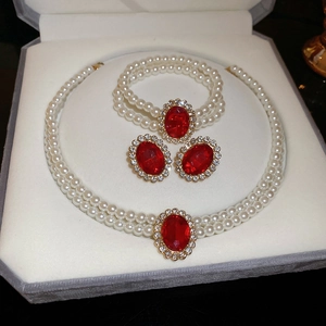Detailed set of double-layer pearl necklace, bracelet and earrings with red oval gemstones