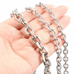 Detail of three stainless steel curb chains in various thicknesses held by hand