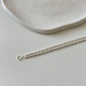 Detail of S925 sterling silver double-layer chain bracelet with spring clasp closure