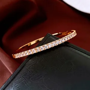 24K gold plated bangle featuring a row of sparkling round zircons on a luxury gift box