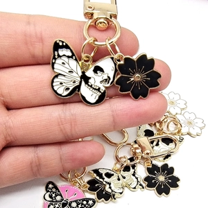 Fashion butterfly and flower enamel metal keychains in black, white, and gold finishes