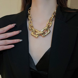 Macro shot of chunky gold chain necklace with oversized interlocking rectangular links