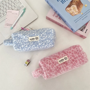 Fuzzy leopard print plush cosmetic bags in blue and pink with soft carrying handles