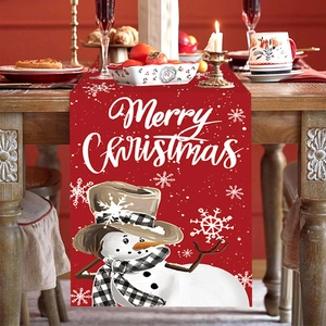 Red Christmas snowman table runner with snowflake patterns and Merry Christmas text on wood