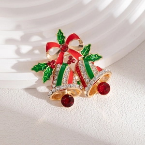 Macro detail of Christmas bell brooch with red bow and sparkling rhinestones