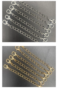 Close-up of gold and silver double-ended lobster clasp extenders for DIY jewelry