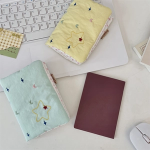 Detailed embroidery of moon and stars on quilted cotton passport and card organizers