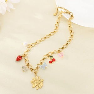 Detailed view of a gold stainless steel bracelet with daisy, fruit, and butterfly charms