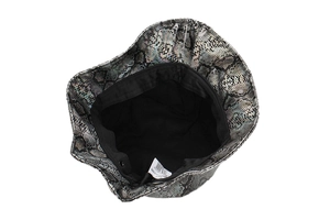 Detail view of the snakeskin textured PVC bucket hat with a black inner lining and tag