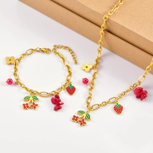 Golden charm jewelry set featuring strawberry and cherry pendants with red coral beads