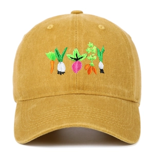 Macro view of detailed vegetable embroidery on washed cotton mustard yellow baseball cap