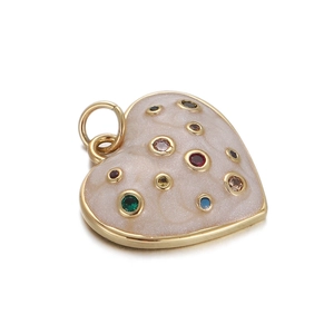 Detailed view of a gold heart-shaped pendant with cream enamel and multicolor crystals