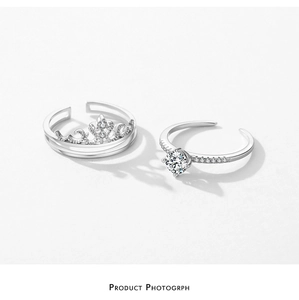 Detail of silver S925 crown rings and adjustable solitaire band with sparkling diamonds