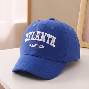 Close-up of white 3D embroidery 'ATLANTA' on a classic navy blue cotton baseball cap