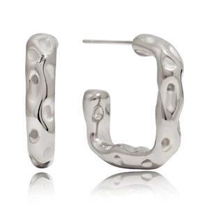 Detailed view of silver C-shaped earrings with textured hammered finish on white background
