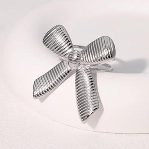 Anello in acciaio inossidabile argento con design a fiocco testurizzato su sfondo bianco