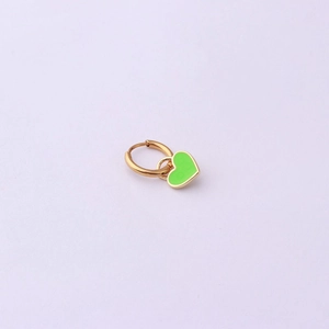 Detailed shot of a gold hoop earring featuring a bright green enamel heart pendant charm