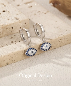 Macro shot of S925 sterling silver evil eye earrings with sparkling blue and white zircon