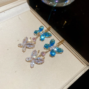 Detail of blue and white butterfly tassel earrings with sparkling zircon stones