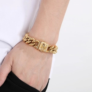 Detail of gold chunky Cuban chain bracelet with skull clasp in street punk style