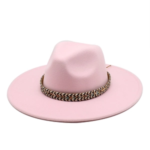 Detailed texture of pink felt fedora with a colorful woven geometric pattern hatband