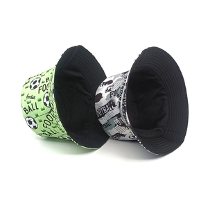 Reversible bucket hat with soccer football patterns and lettering on a white background