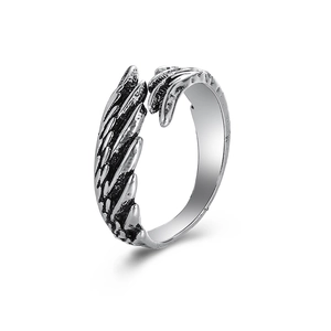 Macro detail of silver feather ring showing oxidized textures and layered wing patterns