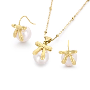 Golden bowknot pearl jewelry set including necklace and earrings on white background