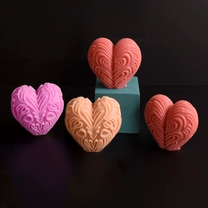 Detailed relief carving on heart-shaped candle molds in multiple pastel colors