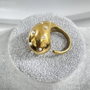 Golden teardrop open ring with white pearls in a sculptural minimalist style