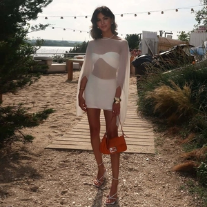 Detail of white mesh chiffon cover-up with matching crop top and skirt for beachwear