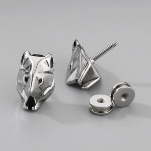 Macro detail of silver stainless steel wolf head stud earrings with secure screw backs