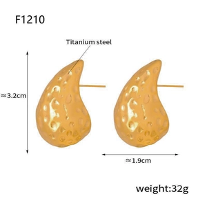 Detail view of 3.2cm golden water drop earrings featuring a unique hammered texture
