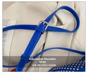 Detail of adjustable blue leather strap with silver buckle and punk style metal rivets