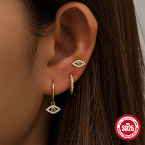 Three-piece S925 sterling silver evil eye gold earring set on female model ear