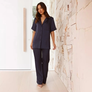 Detailed close-up of dark navy loungewear set featuring button-down collar and satin texture