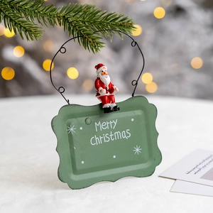 Christmas welcome door sign with Santa Claus figurine and green Merry Christmas plaque