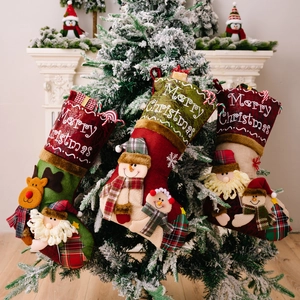 Three 3D plush Christmas stockings with Santa and Snowman hanging on a festive tree