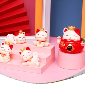 Detailed view of five mini white fortune cat figurines with gold sycee on pink stands