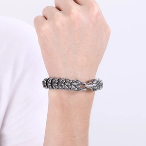 Macro shot of punk eagle head bracelet with detailed scales and vintage silver finish
