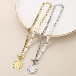 Detail of 18K gold and silver tree of life necklaces with pearls and T-bar toggle clasp