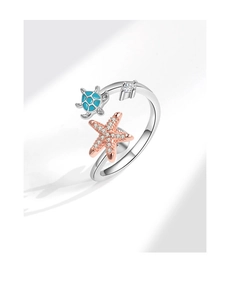 Detail of silver starfish and turtle ring with blue enamel and sparkling crystals