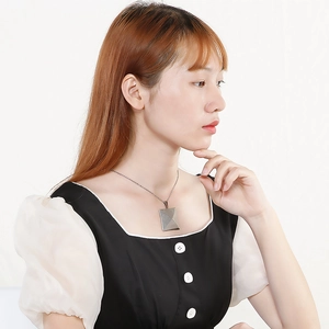 Minimalist silver square block pendant necklace on model with polished stainless steel finish